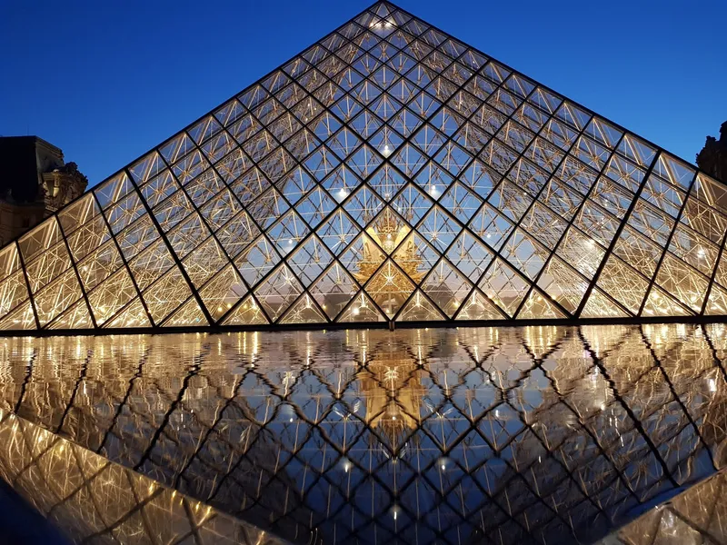 The glass pyramid at dusk — where history meets modernity